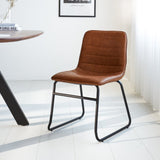 Esszimmerstuhl Mark Dimehouse Cognac LxBxH 74x56x54 Kunstleder Stimmungsvolles Foto schräge Vorderansicht